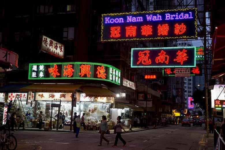 Neon street signs of Hong Kong businesses such as Koon Nam Wah bridal store may be gone soon as they face pressure to switch to LED lights.
