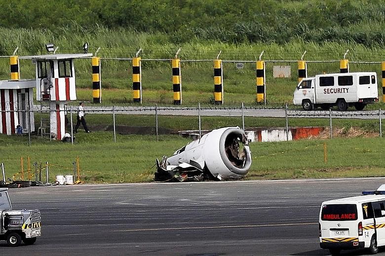 The Xiamen Air plane on the tarmac yesterday after skidding off the runway at Manila's Ninoy Aquino International Airport late on Thursday. Its left engine was ripped off (top left) during the incident.