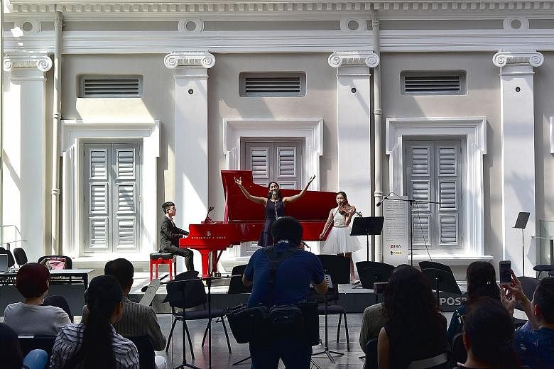 Performing imagin.Asia, an original composition, to an appreciative audience at the National Museum of Singapore yesterday were (from far left) Isaiah Hui, 13, who composed the song, Ms Ananya Diddapur, 18, and Lavinia Tsai, 14. The trio were partici