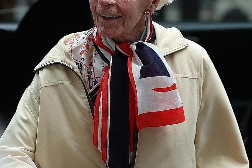 World War II pilot Mary Ellis in central London on May 23, for a reception hosted by Britain's Prime Minister Theresa May as part of the Royal Air Force's 2018 centenary celebrations. Battle of Britain veterans Wing Commander Tom "Ginger" Neil (left)