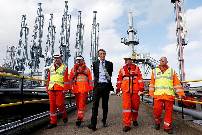 Mr Jim Ratcliffe (in suit) founded the Ineos chemicals group in 1998. The group, in which he owns 60 per cent, now has annual sales of US$60 billion and employs over 18,000 people in 24 countries.