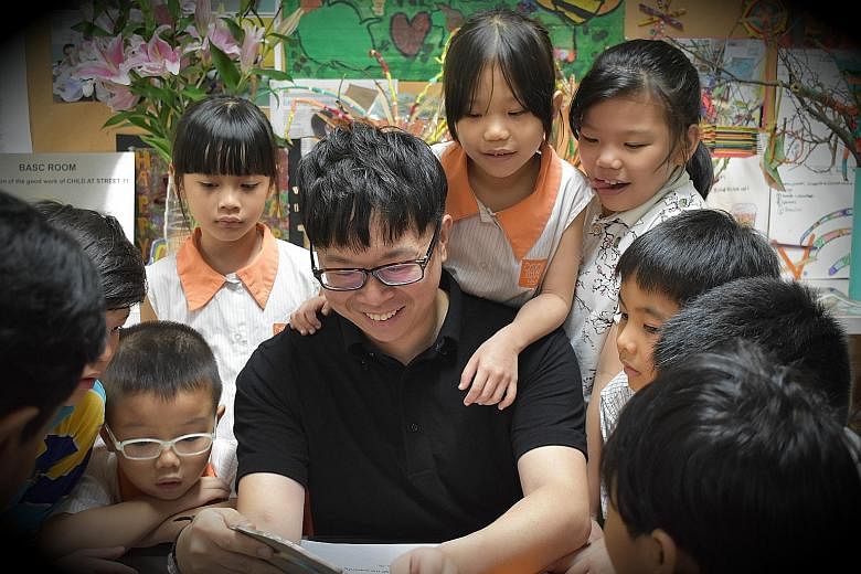 Conductor and composer Wong Kah Chun with children from Project Infinitude, an initiative he co-founded to bring music to underprivileged children and those with special needs.