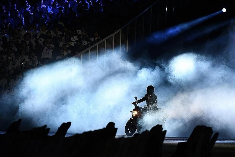A man purporting to be Indonesian President Joko Widodo riding a motorcycle during the opening ceremony of the 2018 Asian Games at the Gelora Bung Karno stadium in Jakarta on Saturday. The video of Mr Joko, a self-confessed motorcycle fan, hopping on