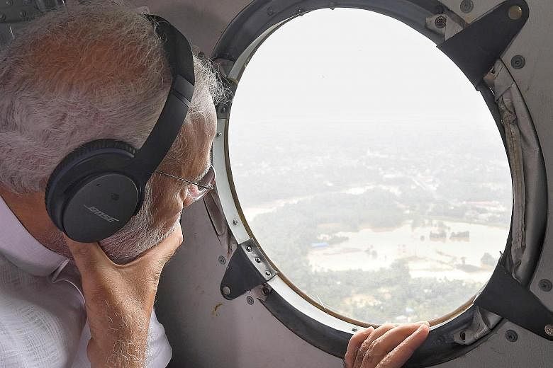 Indian Prime Minister Narendra Modi conducting an aerial survey of the flood-affected areas of Kerala last Saturday. View of a flooded area in the north of Kerala's commercial capital, Kochi. More than 300,000 people who have been displaced since inc