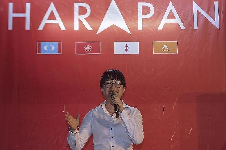 Pakatan Harapan candidate Wong Siew Ki in front of a version of the PH logo, which has an arrowhead replacing the letter "A" in the middle of the word "Harapan". Malaysian Chinese Association candidate Tan Chee Teong (third from left) and other party
