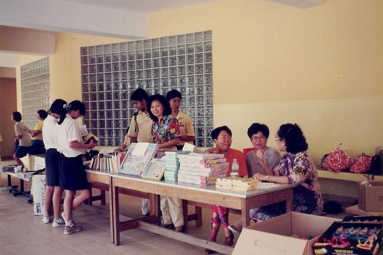 Left: Madam Gladys Tan (middle, in floral top), helping out at the 1995 Fairfield food and fun fair as an alumna. Above, from left: Aaron Ralls, Ann Ralls, Madam Gladys Tan, Andrew Ralls, Andrea Ralls and Mrs Karen Ralls-Tan represent three generatio