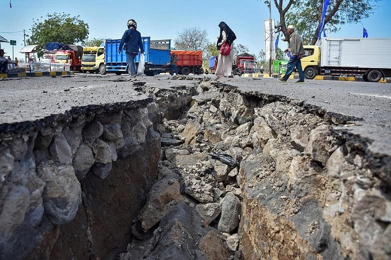 A road at Lombok's Kayangan Port damaged by the Sunday earthquakes. Tens of thousands of homes and businesses on the island had already been destroyed by an earlier quake this month.