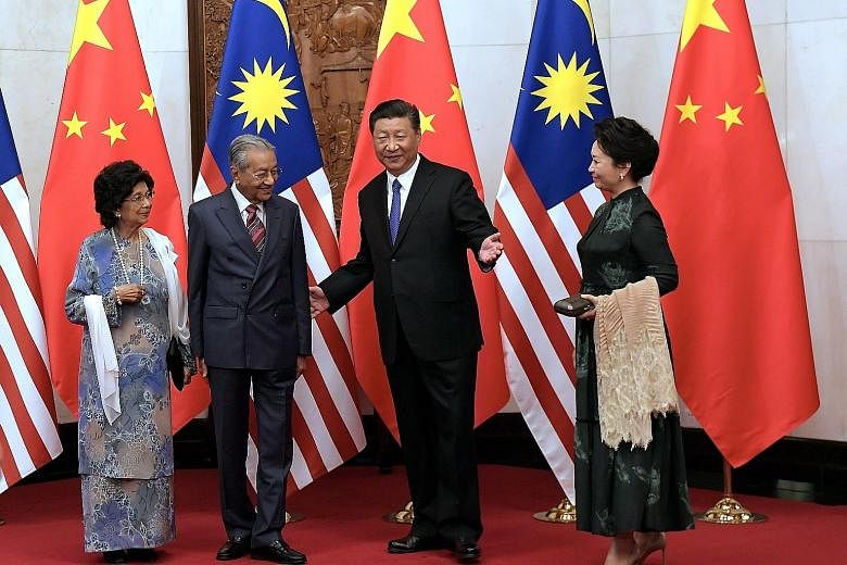 Visiting Malaysian Prime Minister Mahathir Mohamad and his wife Siti Hasmah Mohamad Ali with Chinese President Xi Jinping and his wife Peng Liyuan at the Diaoyutai State Guesthouse in Beijing yesterday. The CCTV state news bulletin reported that Dr M