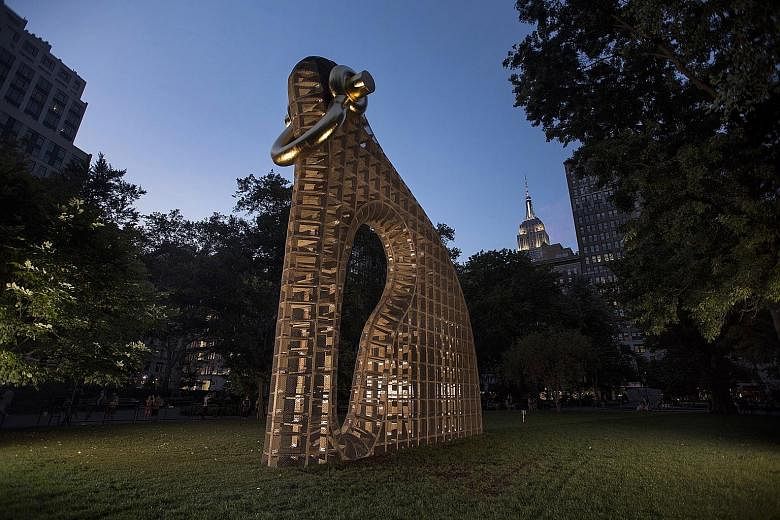 Martin Puryear's sculpture Big Bling, a 12.2m-high construction of plywood and chain-link fencing with a gold-leaf shackle, in Madison Square Park in New York.