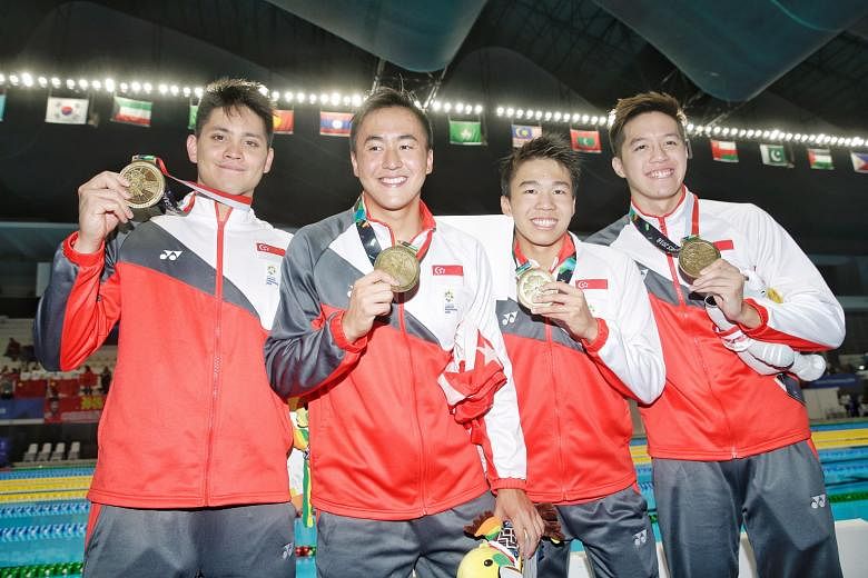 Left: Quah Zheng Wen, Joseph Schooling and Danny Yeo celebrating as Jonathan Tan secures third place in the 4x200m freestyle, Singapore's first podium finish at these Asian Games. Below: (From left) Schooling, Quah, Jonathan and Yeo with their bronze
