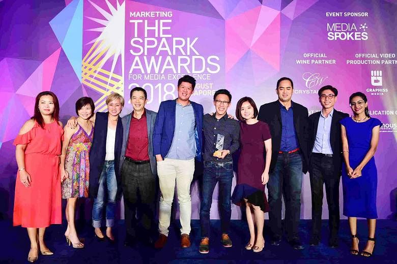 SPHMBO team members (from left) Jesslyn Lock, Julie Wee, Goh Wee Wang, Edward Tang, Denzel Woo, Ian Tan, Clara Cheong, Ken Tay and Caden Cai with a presenter at the Spark Awards for Media Excellence.