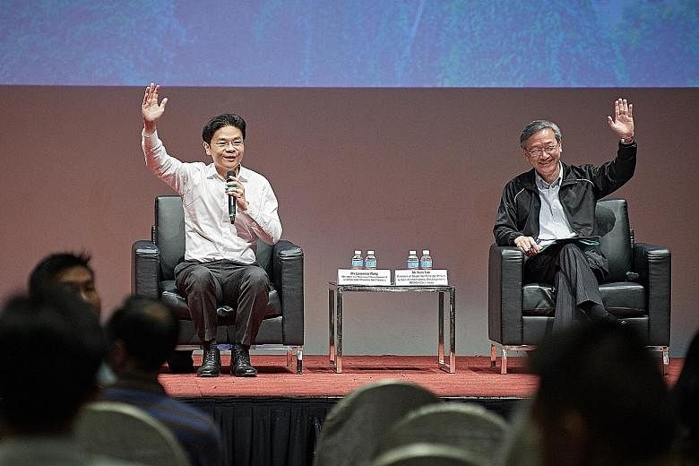 Minister for National Development Lawrence Wong (far left) and Reach chairman Sam Tan getting the audience at yesterday's forum about the National Day Rally to raise their hands if they are among the Merdeka Generation.
