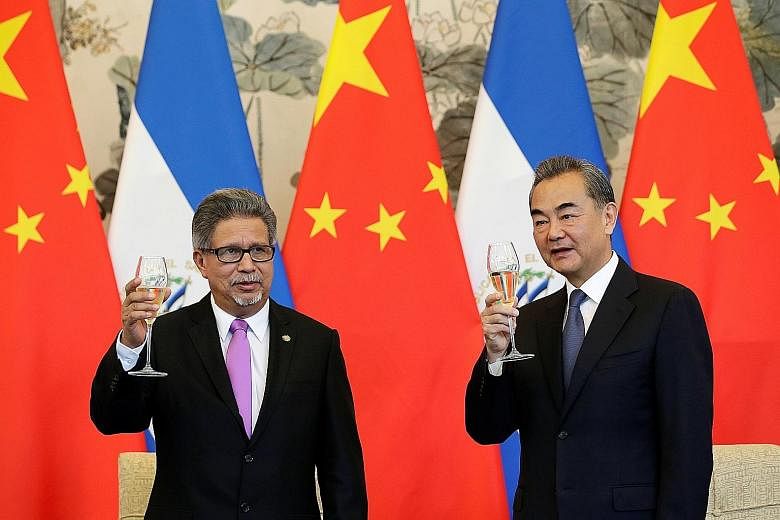 El Salvador's Foreign Minister Carlos Castaneda and his Chinese counterpart Wang Yi toasting their countries' new diplomatic relationship at the Diaoyutai State Guest House in Beijing yesterday. Mr Wang later said El Salvador has committed to abide b