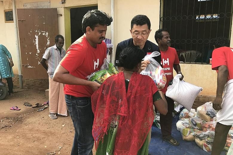 Mercy Relief's acting head of international programmes Masahiro Ishizeki distributing food packets at a relief camp in Aluva, Kerala.