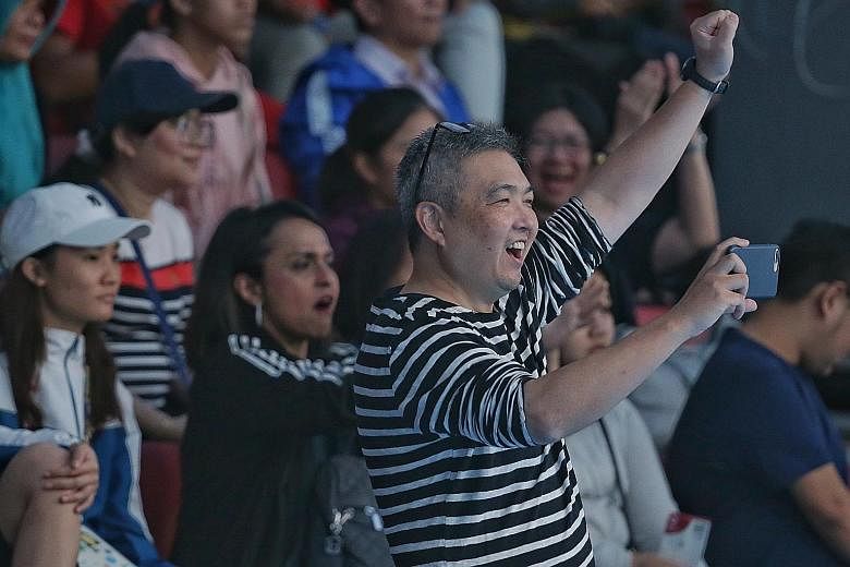 Fencer Maxine Wong's father, Philip (front) and mother Chan Bee Bee (rear, with glasses and clapping), and fencer Amita Berthier's mother Uma (behind Philip) watching them during the Singapore women's foil team's 45-14 semi-final loss to China in Jak