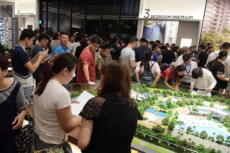 A large crowd of buyers gathered at the Riverfront Residences showflat on July 5, after property cooling measures were announced that day. Some 52 per cent of its 1,472 units have been sold.