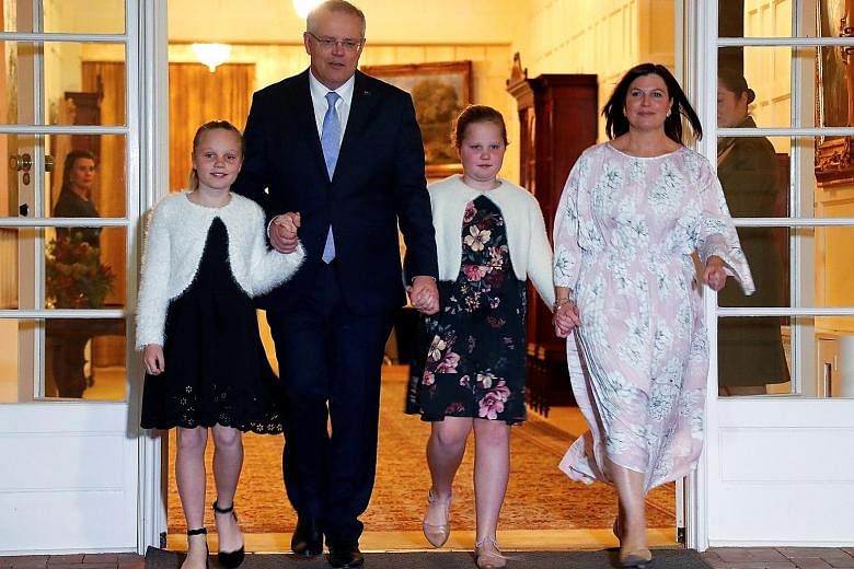 Newly minted Australian Prime Minister Scott Morrison with his wife Jenny and their daughters Lily (far left) and Abbey after the swearing-in ceremony in Canberra yesterday.