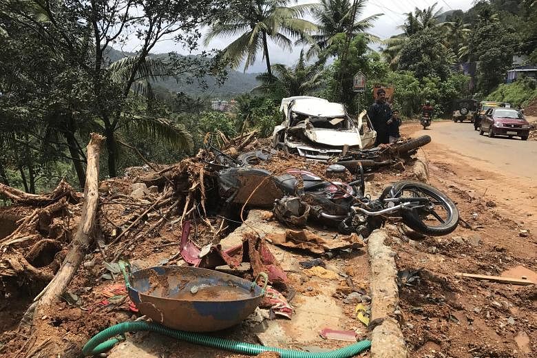 Vehicles damaged by a landslide (above) lining the road to Munnar, a top tourist destination due to its picturesque tea plantations and breathtaking natural beauty. A bridge (right), which locals say was built in the 1920s by the British, lies ruined