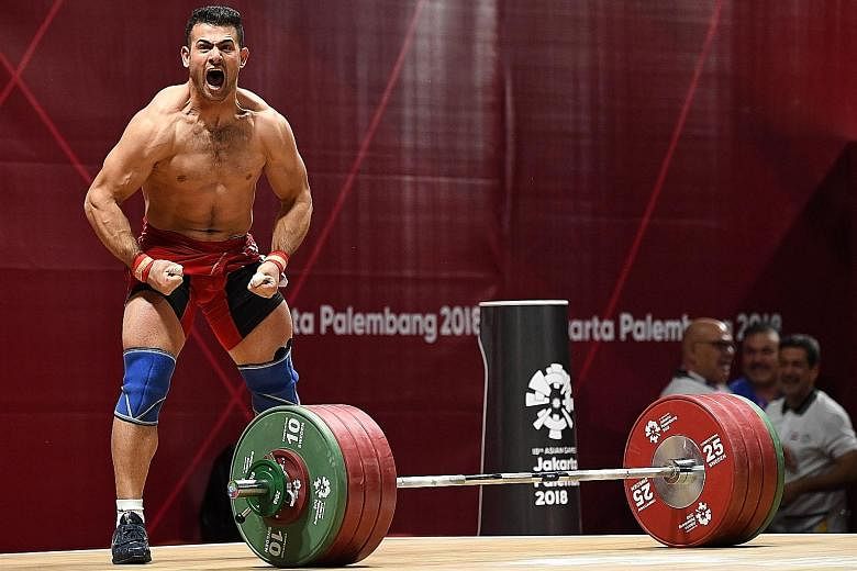 Iraq's Safaa Aljumaili's unbridled and bare-bodied reaction to winning Iraq's first gold of these Games in the 85kg weightlifting event yesterday. He was joined by an equally overjoyed Iraqi official who kissed the platform several times in thanks.