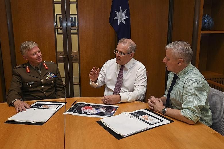 First full day of work for Australia's new Prime Minister Scott Morrison (centre) as he and Deputy Prime Minister Michael McCormack (right) held talks with national drought coordinator Major-General Stephen Day yesterday.