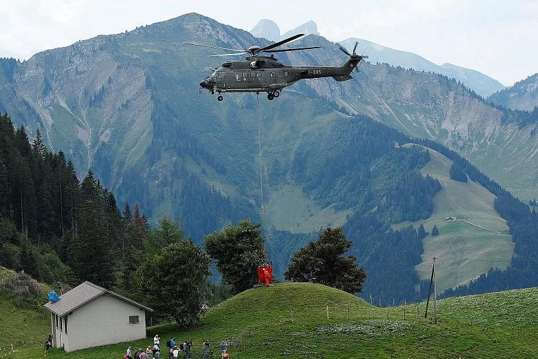 A Swiss Air Force helicopter delivering water for cows in a pasture due to an ongoing drought near Rossiniere, Switzerland, this month. Northern Europe is facing a widespread drought that could see farmers having to send most of their herds to slaugh