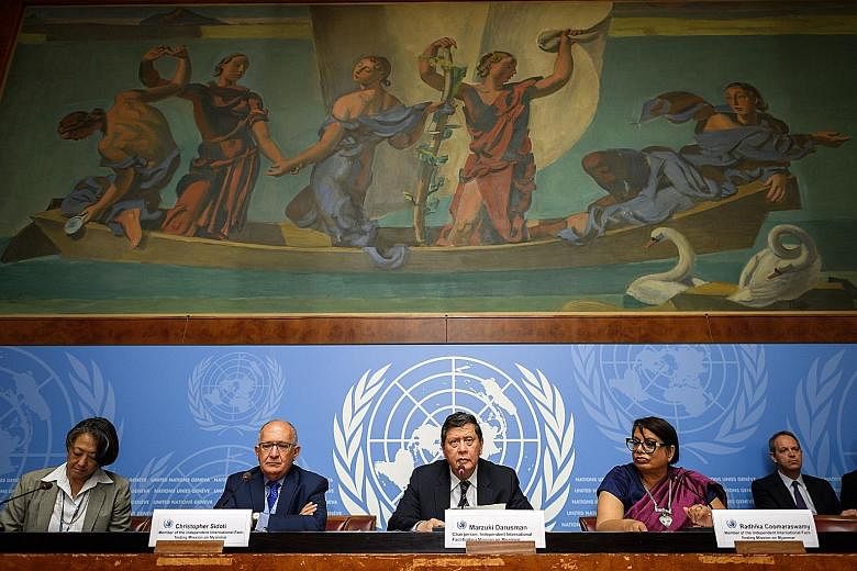 Mr Marzuki Darusman (centre), chairman of the UN's fact-finding mission, flanked by members Christopher Sidoti and Radhika Coomaraswamy at a press conference on the report yesterday. Rohingya refugees taking part in a protest last Saturday at a camp 