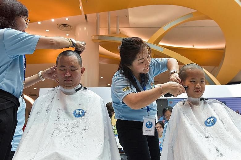 Mr Ken Lim and his son Javier having their heads shaved for Hair for Hope in July. This is Javier's 10th time participating in the event to show support for cancer patients. His selflessness and positive outlook on life won him a Singapore Health Ins