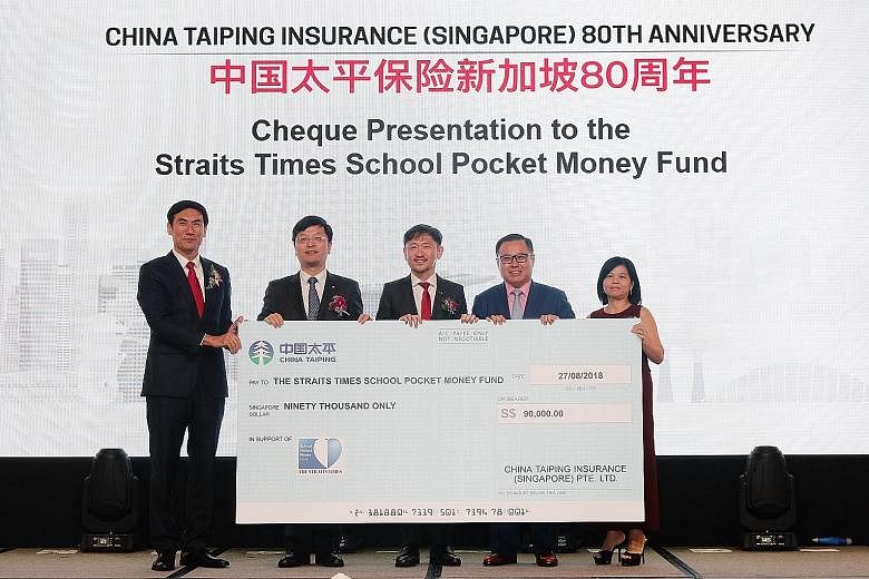 From left: China Taiping Insurance Singapore general manager Yang Yamei; China Taiping Insurance Singapore chairman Hong Bo; Singapore Press Holdings deputy chief executive Anthony Tan; The Straits Times School Pocket Money Fund trustee Arthur Lang a