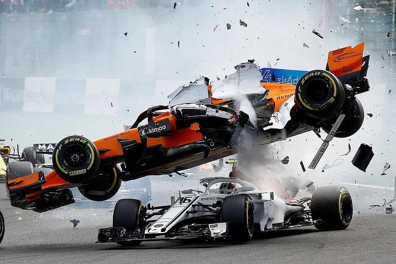 After being hit by Nico Hulkenberg's Renault at the first corner of Sunday's Belgian Grand Prix at the Spa-Francorchamps circuit, Fernando Alonso's McLaren turns turtle on top of Charles Leclerc's Sauber, going across his cockpit. While the halo at t