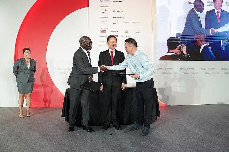 Minister for Trade and Industry Chan Chun Sing looks on as Mr Mamadou Lamine Gueye, chief executive of Compagnie Senegalaise de Transport Transatlantique Afrique de l'Ouest, and Mr Raymond Wong, managing director of Singapore-based design and constru