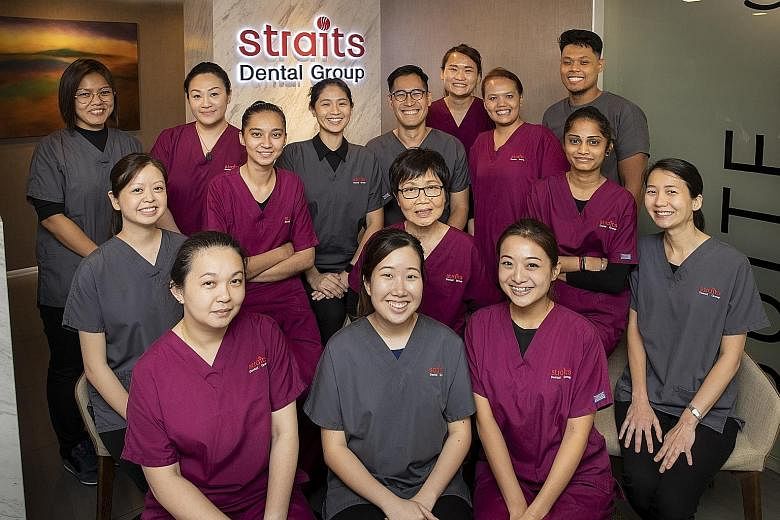 Dr Jeremy Cheah (with spectacles) with members of his staff. Besides dental treatments, he also performs facial aesthetic procedures, such as injecting Botox, fillers and skin boosters.