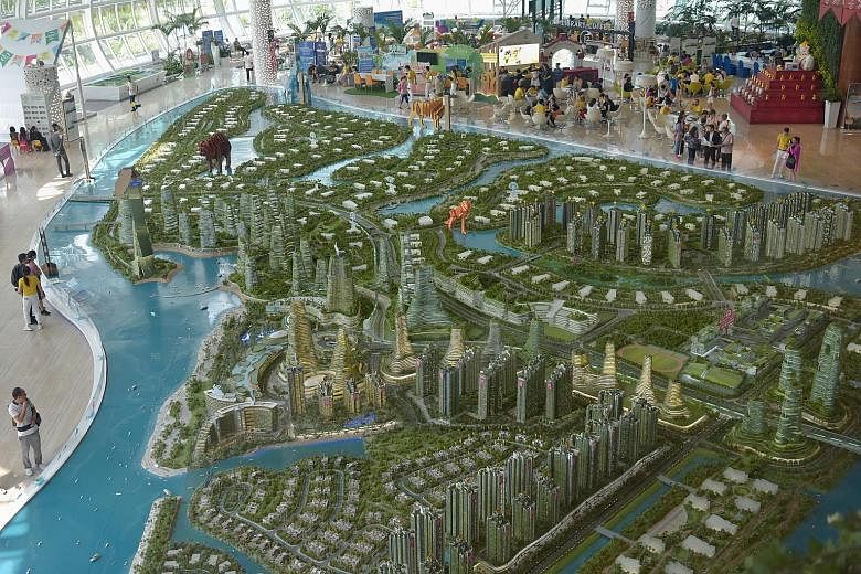 A model of Forest City on display at the showflat gallery in Johor Baru yesterday. The project, developed by Hong Kong-listed Country Garden, has been largely sold to Chinese buyers attracted to the sea views and clean air.