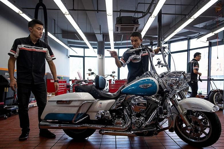 Workers preparing a Harley-Davidson motorcycle for sale at a dealership in Shanghai. From Harley-Davidson motorcycles and US bourbon to Chinese parts and machinery, the world's two largest economies have exchanged punitive tariffs across a wide swath