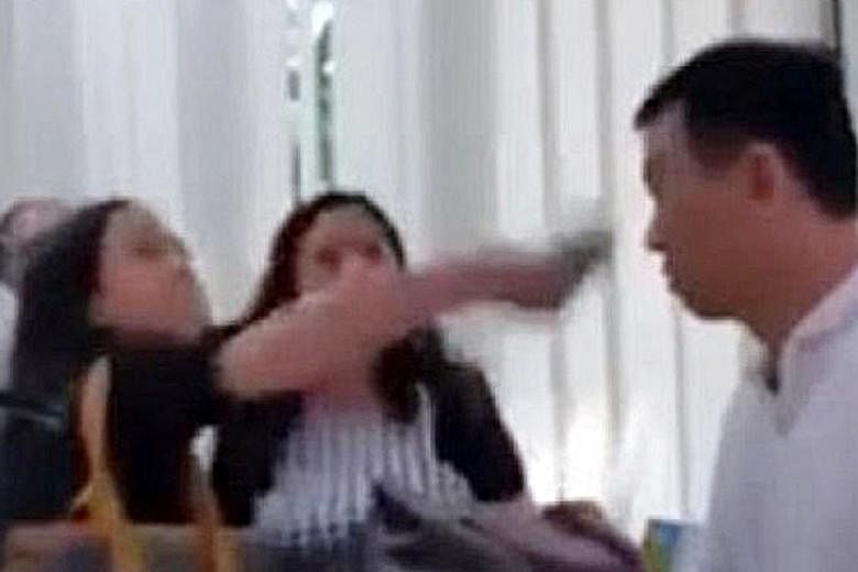 Screengrabs of the video posted online showing (left) one sister splashing a drink at condominium manager Colvin Quek Choon Kiat and (right) the other sister about to hit him. They also caused hurt to security officer Charles Kenneth Bligh.