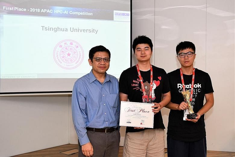 National Research Foundation president George Loh with master's students Xu Ping (centre), 23, and Ma Teng, 24, who were part of the Tsinghua University team that won the competition.