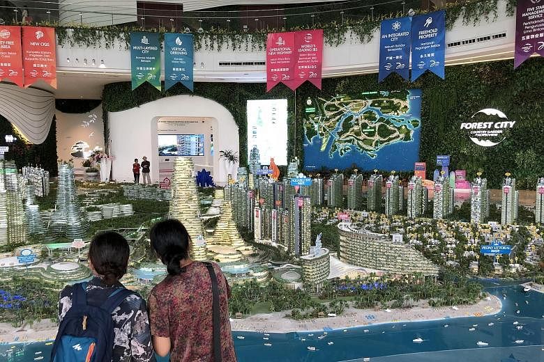 Visitors at the Forest City showroom in Johor Baru on Tuesday. Dr Mahathir Mohamad said on Monday that foreigners will be blocked from buying units in developer Country Garden's project and refused visas to live there.