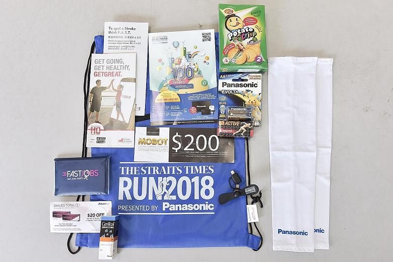 Above: Members of SPD, formerly the Society for the Physically Disabled, filling race packs (left) for participants of the ST Run on Sept 23. The value of the race pack, including items and offers, is over $300.