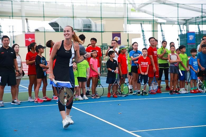 Former world No. 1 Martina Hingis enjoying herself during a coaching session for 40 young tennis players from ActiveSG at Heartbeat@ Bedok yesterday.