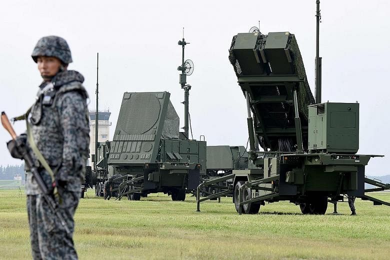 Patriot Advanced Capability-3 surface-to-air missile launch systems set up for a temporary deployment drill at the US Yokota Air Base in Tokyo in August last year. Besides seeking funding to improve the range and accuracy of its PAC-3 missiles, Japan