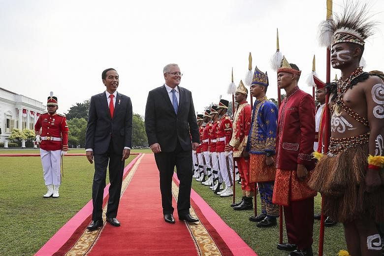 Indonesian President Joko Widodo with visiting Australian Prime Minister Scott Morrison at a welcome ceremony at the Bogor presidential palace in West Java yesterday.