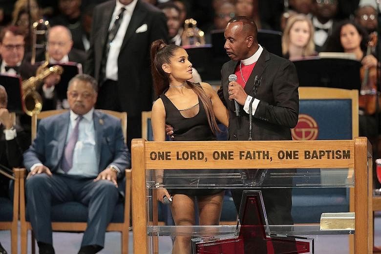 Singer Ariana Grande with Bishop Charles Ellis III after performing at Aretha Franklin's funeral at the Greater Grace Temple in Detroit last Friday. The bishop later also apologised for joking about her name.