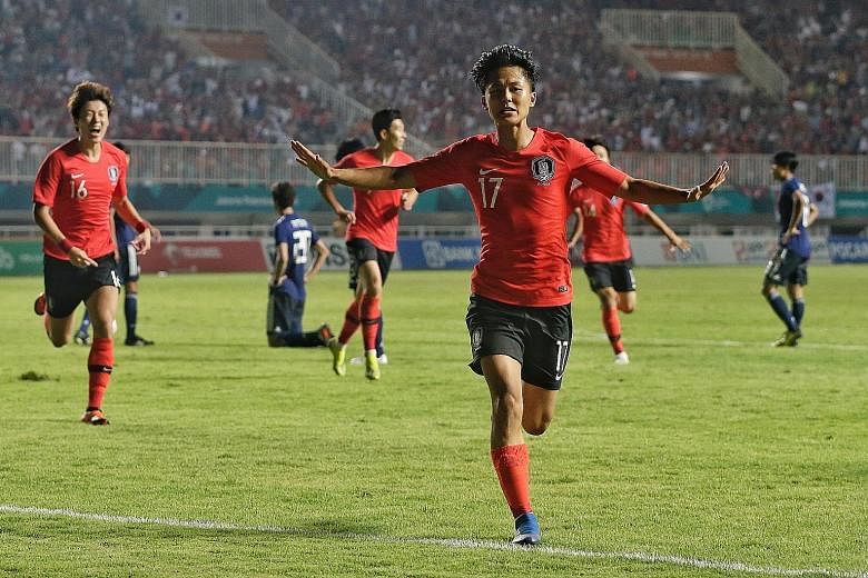Lee Seung-woo celebrating after opening accounts against Japan in extra time in the final in Bogor yesterday. South Korea won 2-1.