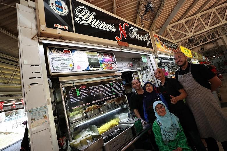 Hawker-entrepreneur Jason Chua Mr Ong Ah Chai, 77, and his wife Madam Lee Bay Lee, 73, at his former food stall, Yuan Chun Famous Lor Mee stall in Amoy Street Food Centre. (From left) Siblings Norazman Yunos, 53, Normah Yunos, 62, Ezzat Yunos, 55, an