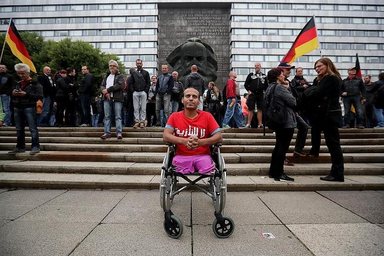 An Iraqi man in a wheelchair wearing a "No Nazi" T-shirt in protest against a gathering of right-wing supporters in Chemnitz, Germany, on Saturday.