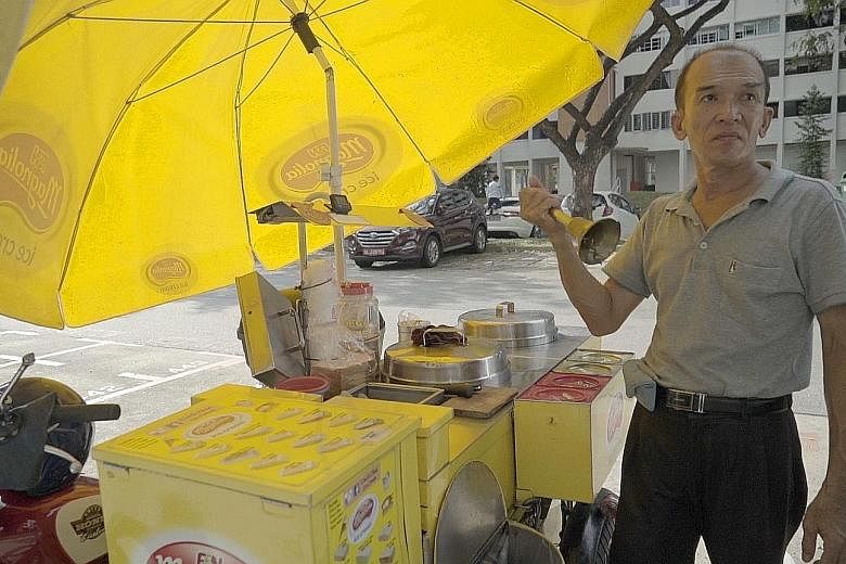 Mr Chua Kheng Lee at work with his motorbike cart. He serves ice cream in the traditional ways, such as wrapped in bread, or sandwiched between two wafers, in addition to the standard wafer cone.