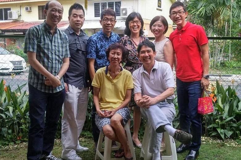 Mr Raymond Tan (standing, second from left) and six other former pupils of Delta West School with their teacher Tan Siam Tiam (seated) at her Stirling Road home during Chinese New Year in 2016.