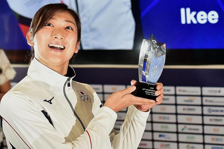 Japanese swimmer Rikako Ikee with her Most Valuable Player trophy in Jakarta after being named the best athlete at the Asian Games. The 18-year-old was given the award after becoming the first woman to win six gold medals at a single Asiad.