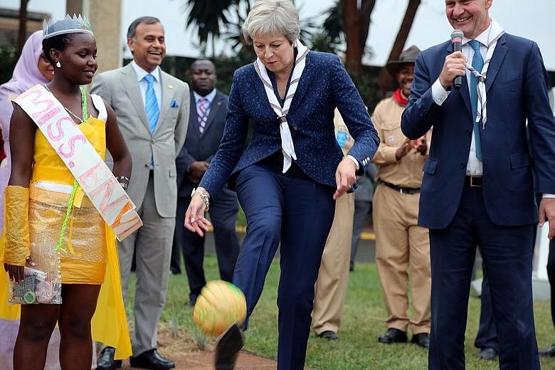 British Prime Minister Theresa May kicking a ball made of recycled plastic on her visit to the United Nations complex in Nairobi last week.