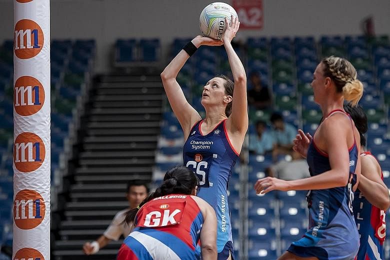 Goal-shooter Krystle Edwards attempting to score as Hong Kong beat the Philippines 73-15 in their final Pool D game at the OCBC Arena yesterday to qualify for the M1 Asian Netball Championship Cup group, alongside Singapore, Malaysia and Sri Lanka. T
