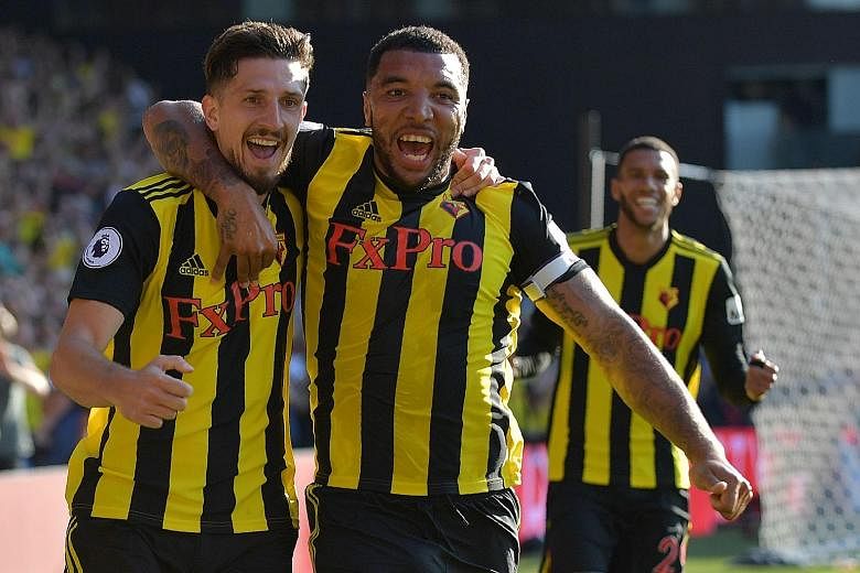 Watford defender Craig Cathcart (far left) and striker Troy Deeney make a happy pair after the former scored the winner against Tottenham in their league match. Deeney had netted the equaliser at Vicarage Road on Sunday.
